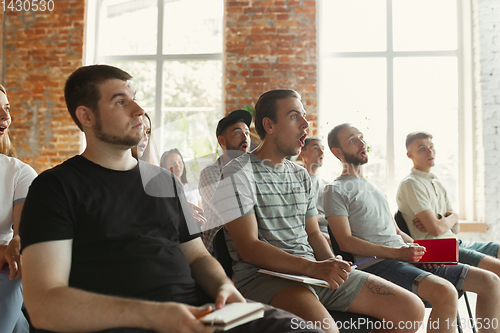 Image of Students listening to presentation in hall at university workshop