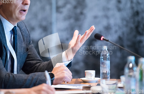 Image of close up of business people taking notes