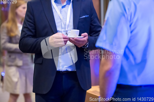 Image of closeup of businessman holding a cup of coffee