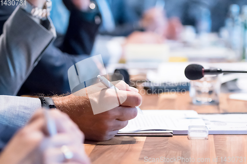 Image of close up of business people taking notes