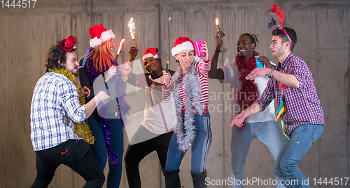 Image of multiethnic group of casual business people dancing with sparkle