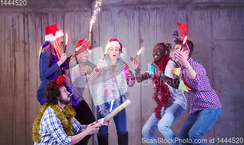 Image of multiethnic group of casual business people dancing with sparkle