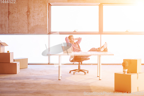 Image of young casual businessman taking a break on construction site