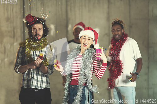 Image of multiethnic group of casual business people having confetti part