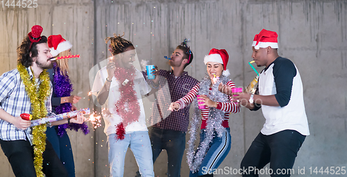 Image of multiethnic group of casual business people having confetti part