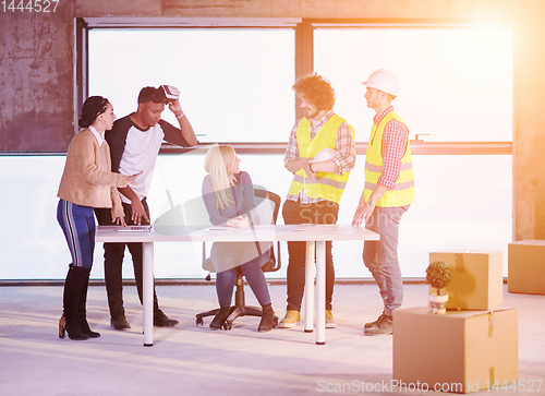 Image of group of multiethnic business people on construction site