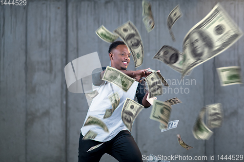 Image of black businessman making the rain of money