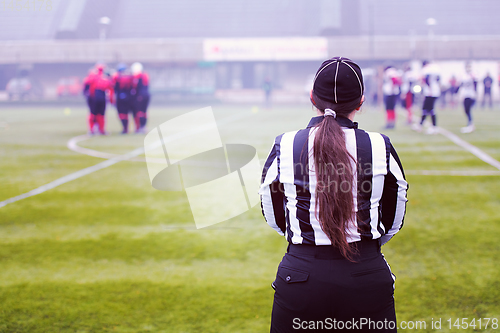 Image of rear view of female american football referee