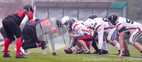 Image of professional american football players ready to start