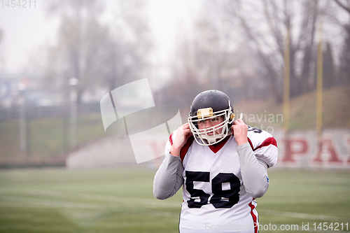 Image of portrait of young confident American football player