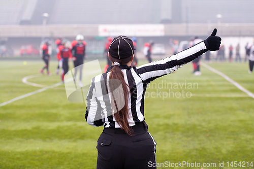 Image of rear view of female american football referee