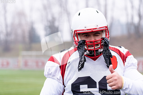 Image of portrait of young confident American football player