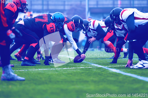 Image of professional american football players ready to start