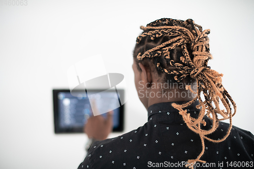 Image of African man using smart home screen