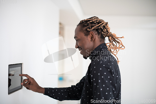 Image of African man using smart home screen