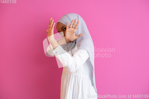 Image of african muslim woman showing two hands stop gesture against vilo