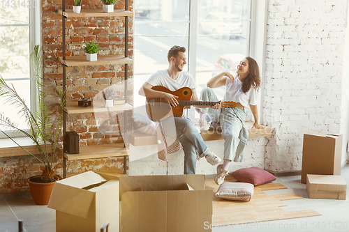 Image of Young couple moved to a new house or apartment