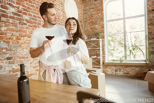 Image of Young couple moved to a new house or apartment