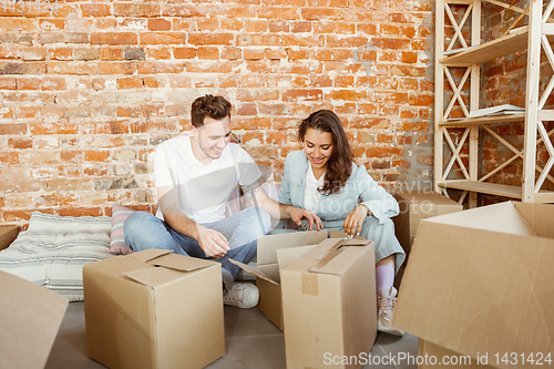 Image of Young couple moved to a new house or apartment