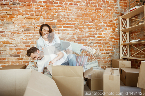 Image of Young couple moved to a new house or apartment