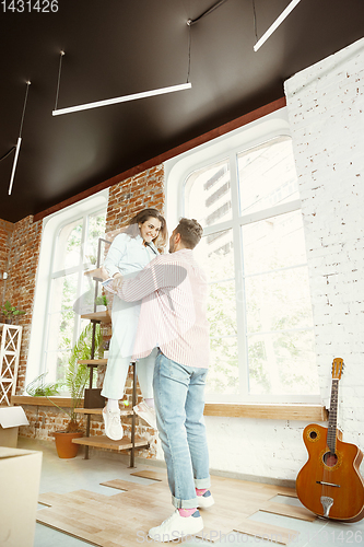 Image of Young couple moved to a new house or apartment