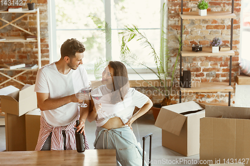 Image of Young couple moved to a new house or apartment