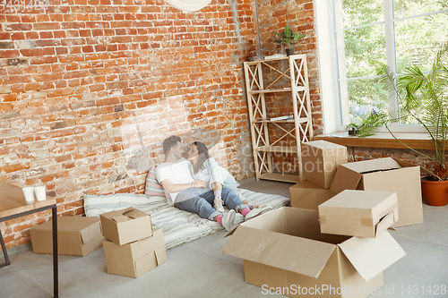 Image of Young couple moved to a new house or apartment