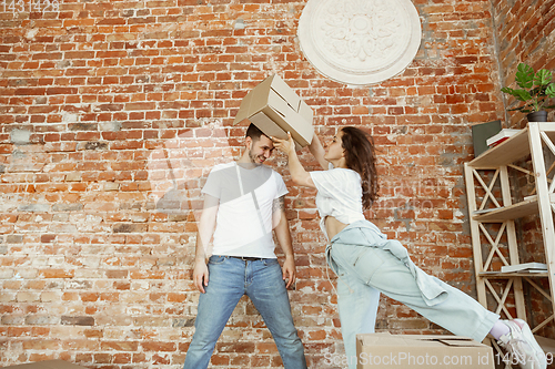 Image of Young couple moved to a new house or apartment