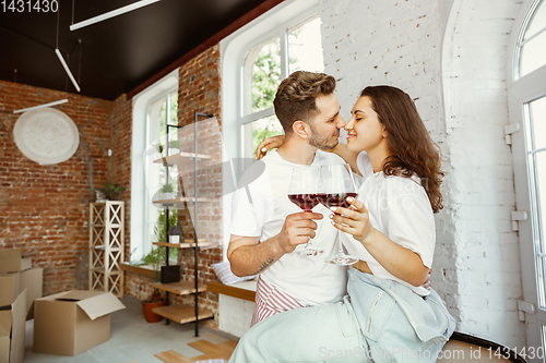 Image of Young couple moved to a new house or apartment