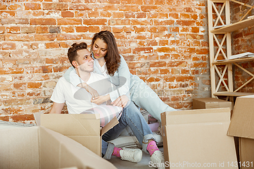 Image of Young couple moved to a new house or apartment