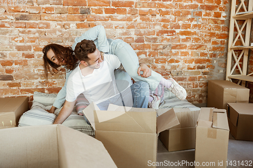 Image of Young couple moved to a new house or apartment