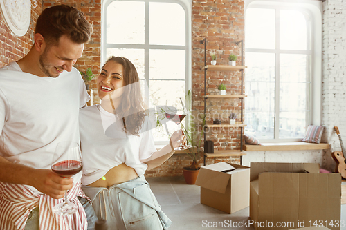 Image of Young couple moved to a new house or apartment