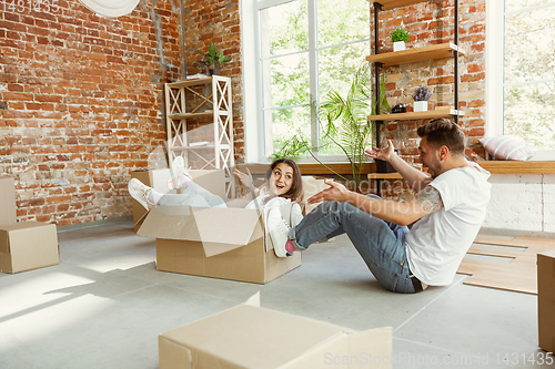 Image of Young couple moved to a new house or apartment