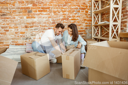 Image of Young couple moved to a new house or apartment