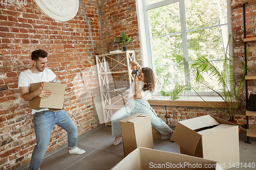 Image of Young couple moved to a new house or apartment