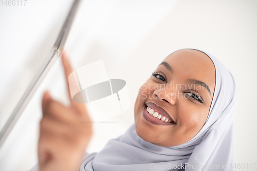 Image of african woman using smart home screen