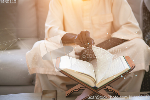 Image of african couple at home reading quaran