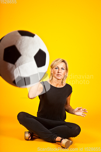 Image of woman playing with a soccer ball