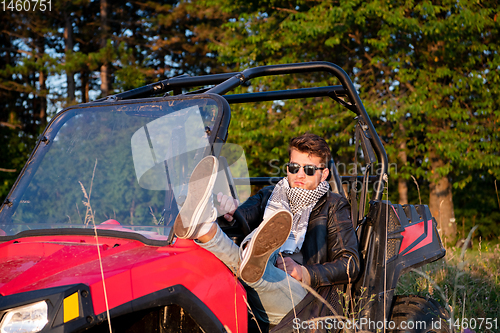 Image of portrait of young man driving a off road buggy car