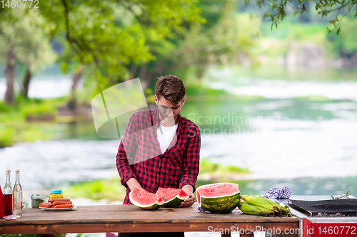 Image of Man cutting watermelon