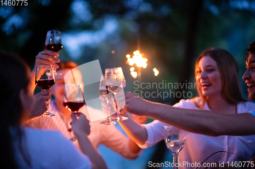 Image of happy friends having french dinner party outdoor