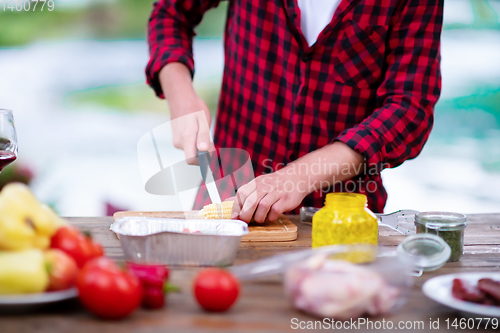 Image of Man cutting vegetables for salad or barbecue grill