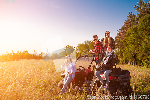 Image of group of young people driving a off road buggy car