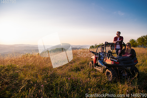 Image of group of young people driving a off road buggy car