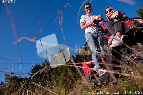 Image of young couple driving a off road buggy car