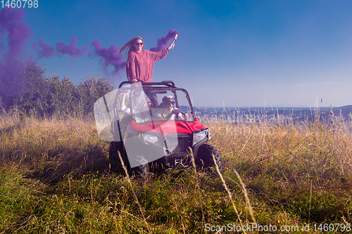 Image of group of young people having fun while driving a off road buggy 