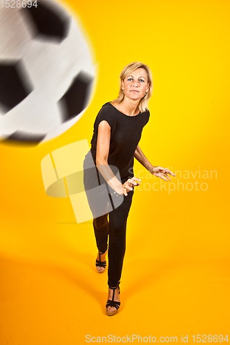 Image of woman playing with a soccer ball