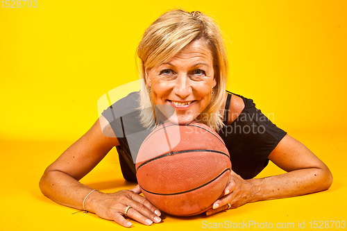 Image of woman posing with a basket ball