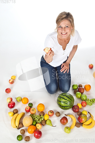 Image of Blond cute woman eating an apple