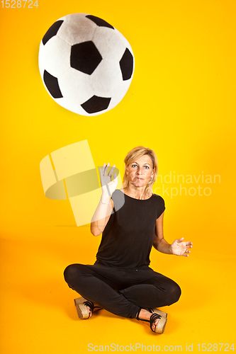 Image of woman playing with a soccer ball